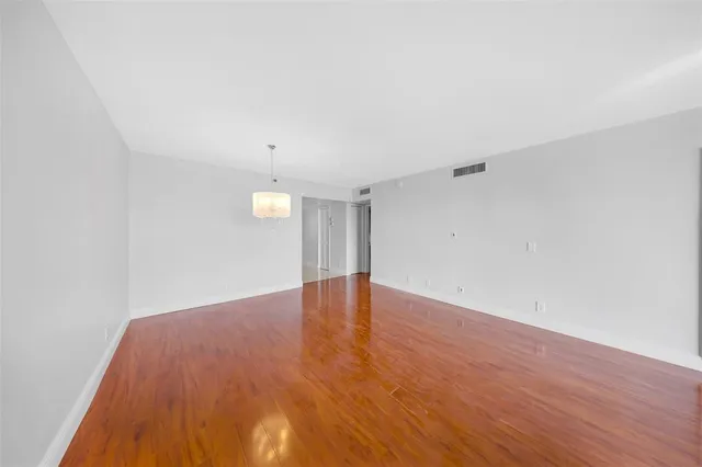 a view of an empty room and wooden floor