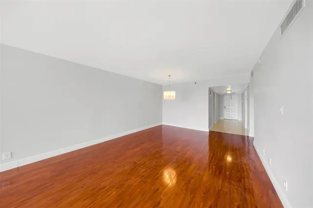 a view of an empty room and wooden floor