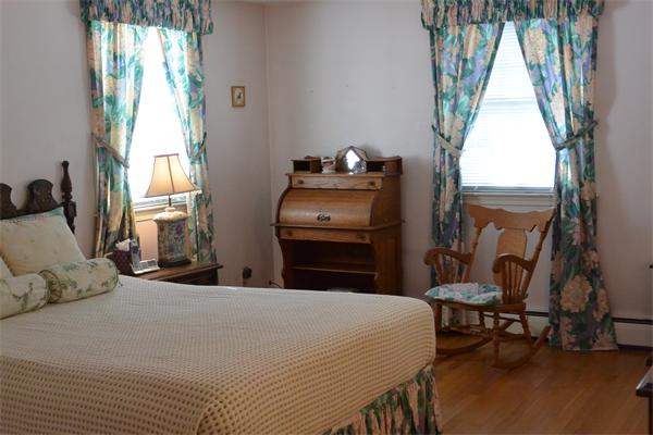 6 Hancock Road Needham, MA 02492 - Photo 12 of 19 a bedroom with a bed a table and chair