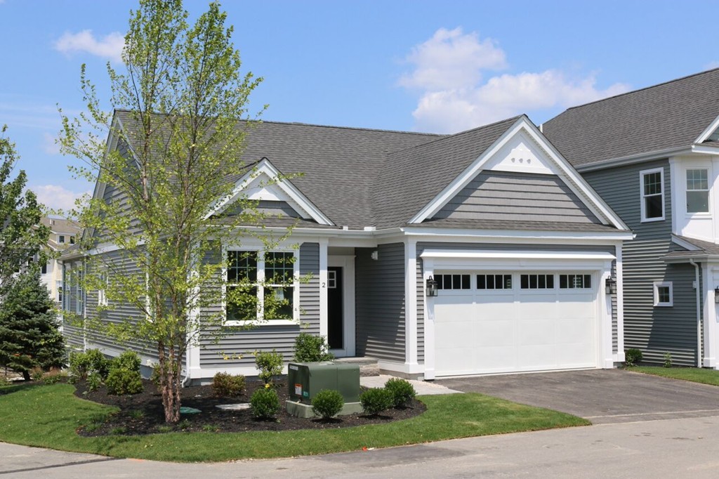 121 Oxbow Road Wayland, MA 01778 - Photo 1 of 3 a front view of a house with a yard and garage