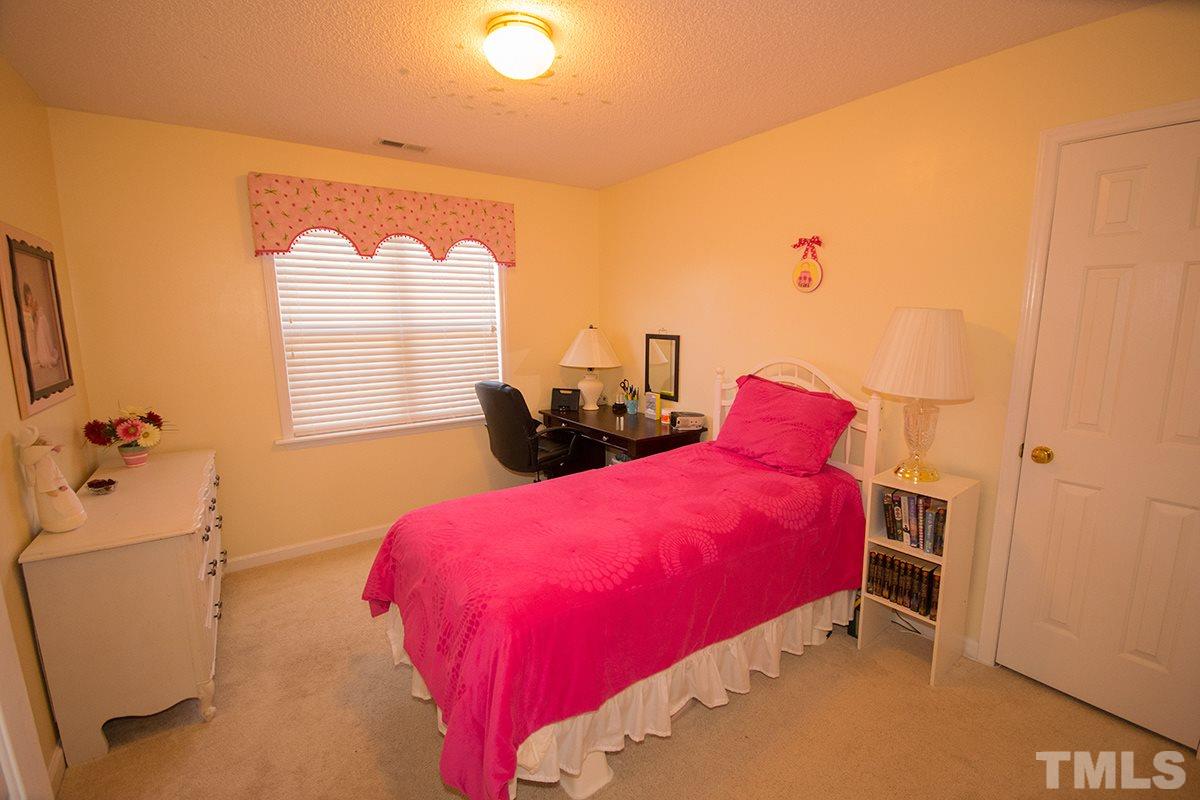 1012 Holland Ridge Drive Raleigh, NC 27603 - Photo 22 of 25 a bedroom with a bed and a window
