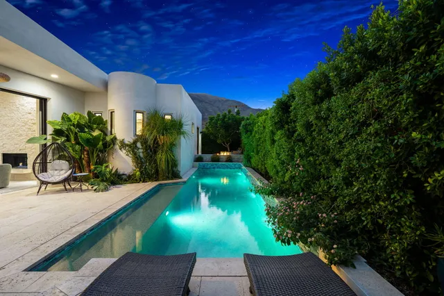 a view of a swimming pool with a yard