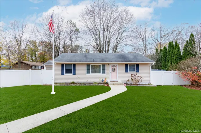 a front view of a house with a yard and trees