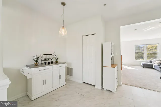 a kitchen with a sink a counter top space appliances and cabinets