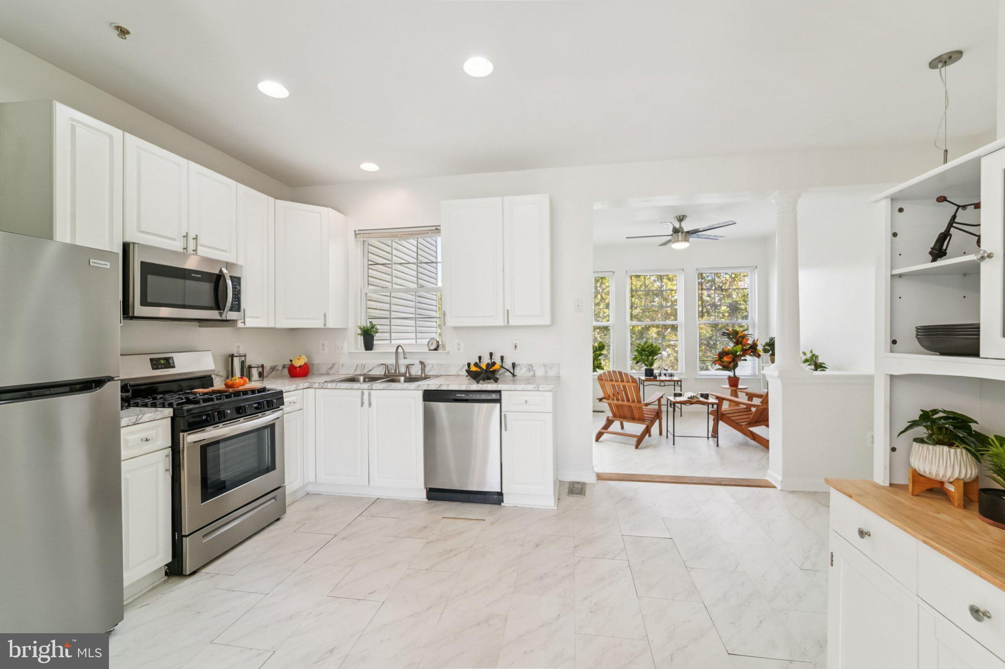 1007 Carbondale Way Crofton, MD 21114 - Photo 13 of 24 a kitchen with a sink a counter top space appliances and cabinets
