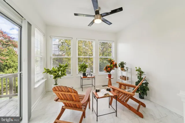 a living room with chairs and a dining table with wooden floor