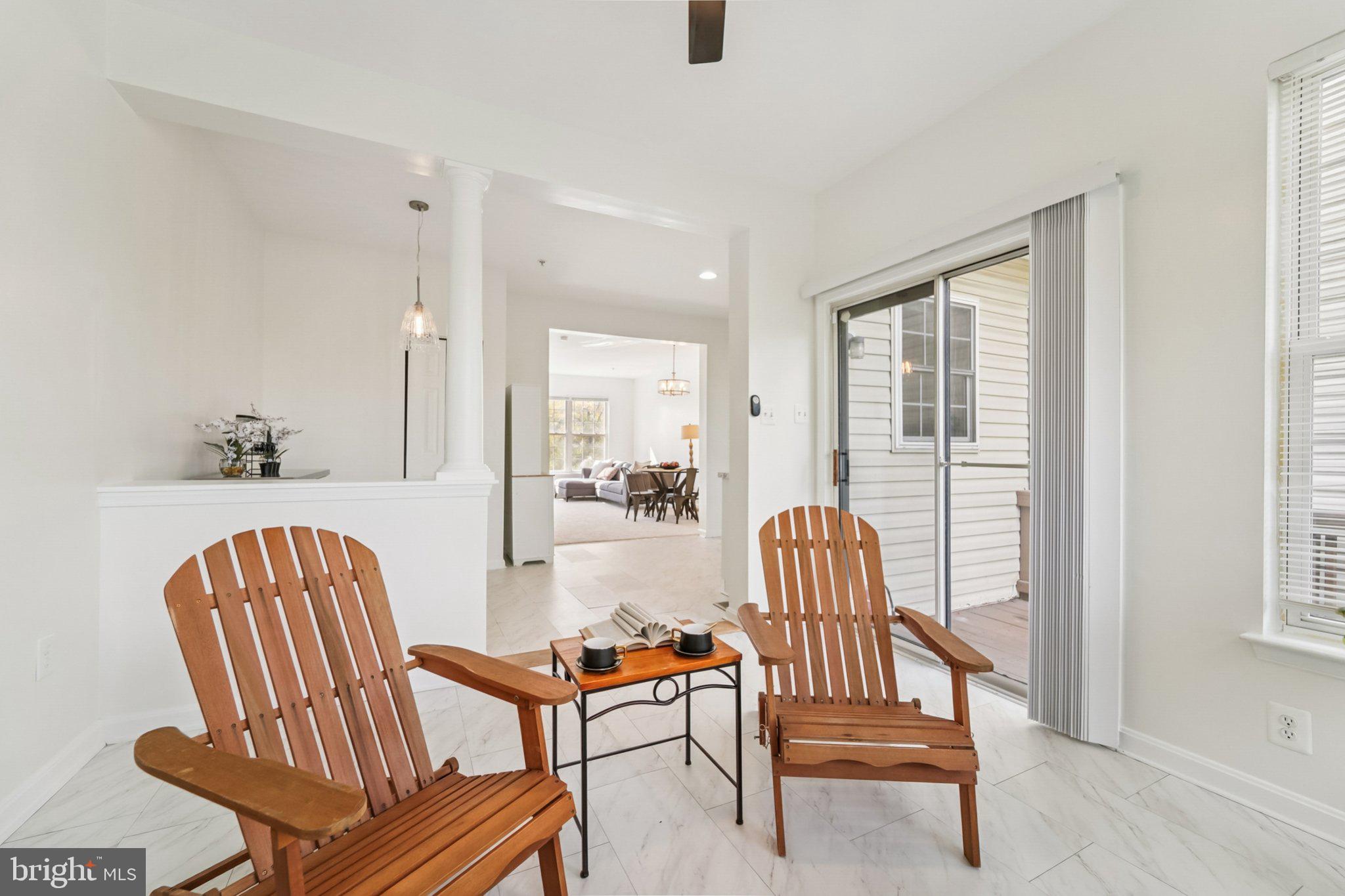 1007 Carbondale Way Crofton, MD 21114 - Photo 15 of 24 a living room with chairs and a dining table with wooden floor