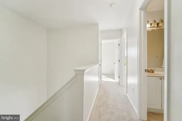 a spacious bedroom with a bed and lamp