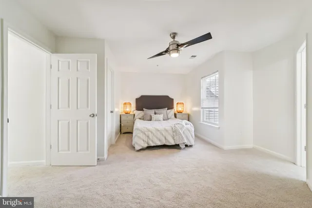 a bedroom with a bed a chandelier and closet