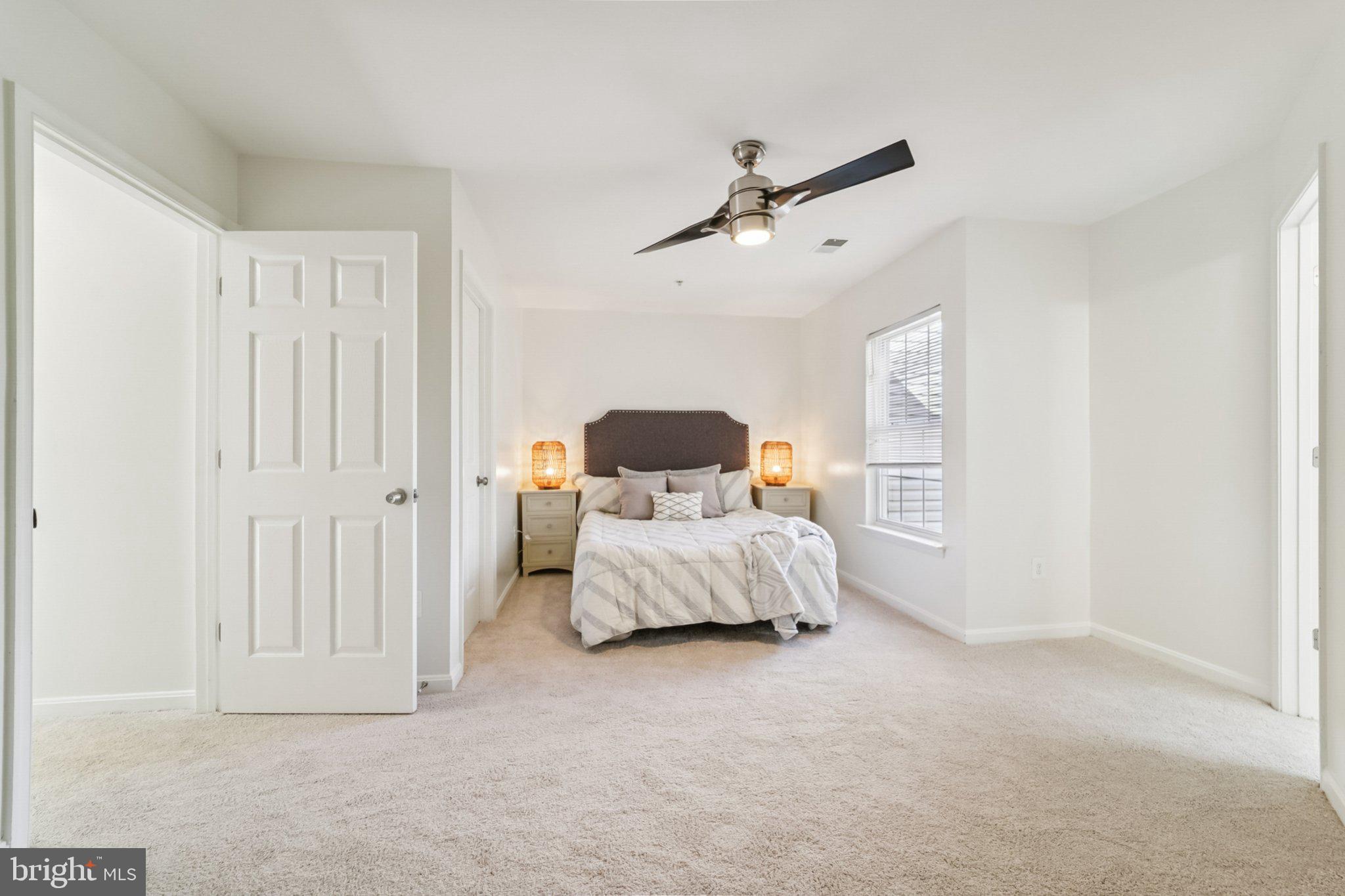 1007 Carbondale Way Crofton, MD 21114 - Photo 17 of 24 a spacious bedroom with a bed and lamp