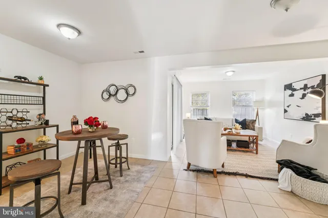 a view of a dining room with furniture and a kitchen