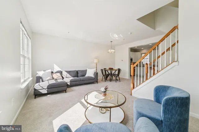 a living room with furniture and a dining table