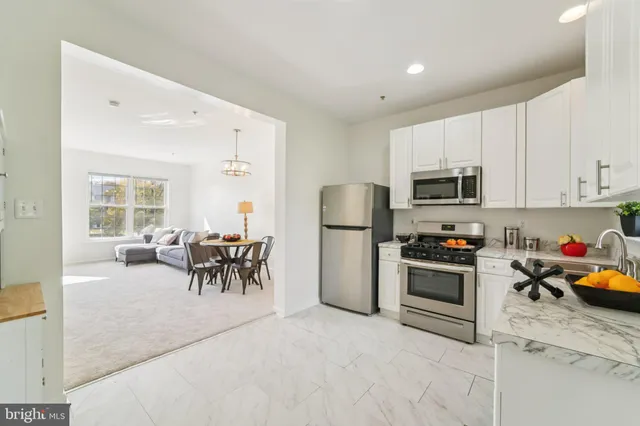 a view of kitchen with sink and refrigerator