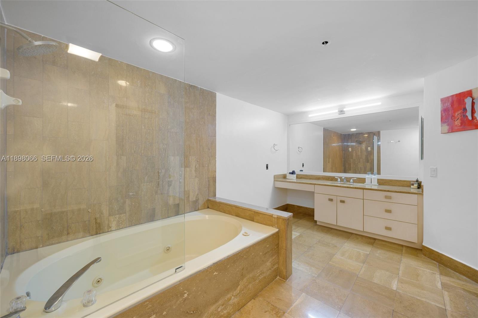 1581 Brickell Avenue, Unit 2005 Miami, FL 33129 - Photo 18 of 38 a bathroom with a tub a sink double vanity and a mirror