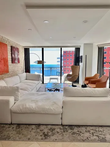 a living room with furniture and large mirror