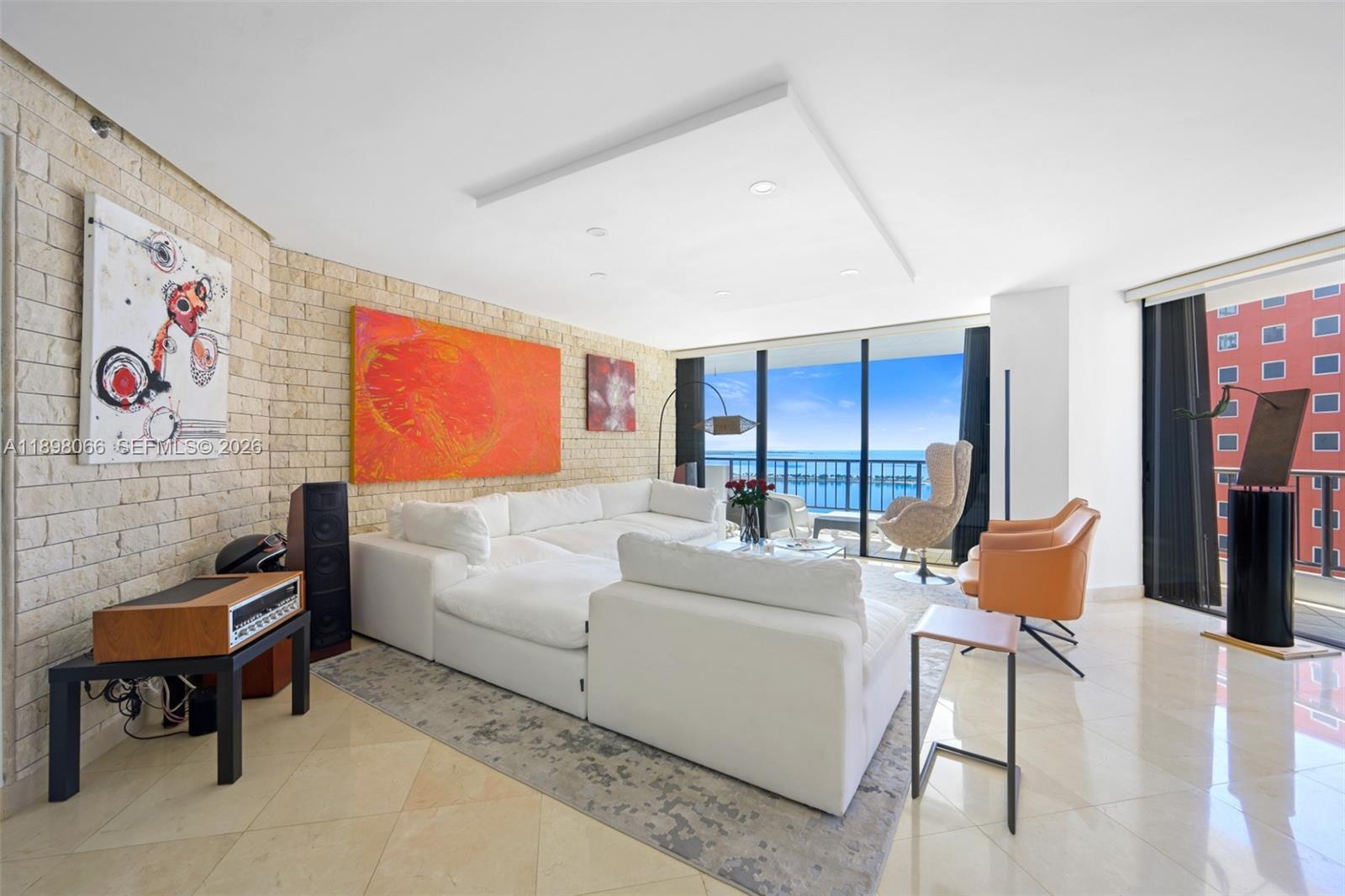 1581 Brickell Avenue, Unit 2005 Miami, FL 33129 - Photo 2 of 38 a living room with furniture and a large window