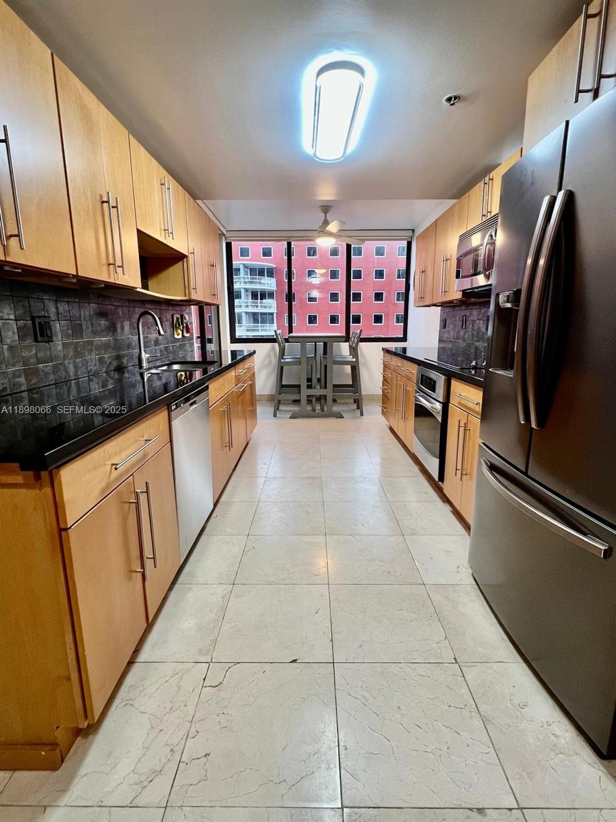 1581 Brickell Avenue, Unit 2005 Miami, FL 33129 - Photo 21 of 51 a kitchen with stainless steel appliances granite countertop a sink and cabinets