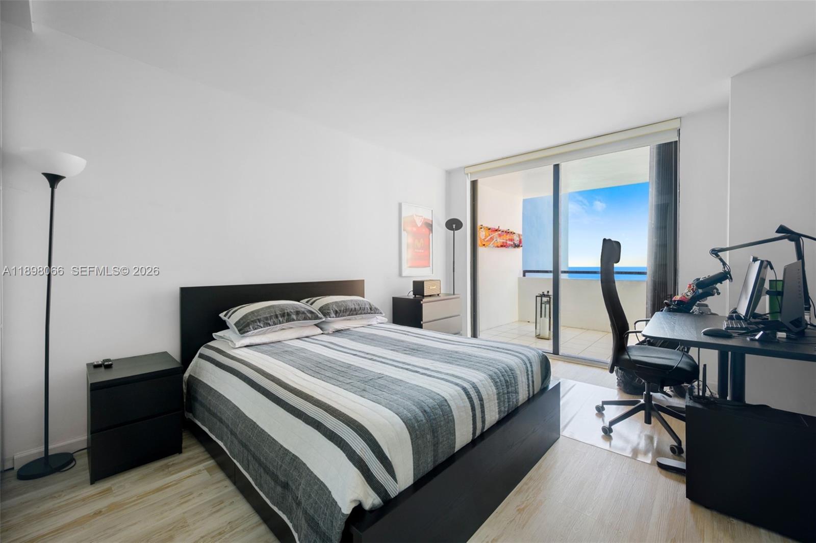 1581 Brickell Avenue, Unit 2005 Miami, FL 33129 - Photo 23 of 38 a bedroom with a bed and wooden floor