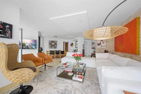 a living room with furniture kitchen view and a large window
