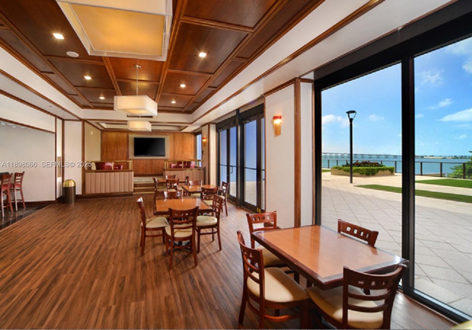 1581 Brickell Avenue, Unit 2005 Miami, FL 33129 - Photo 43 of 51 a dining room with furniture window and wooden floor