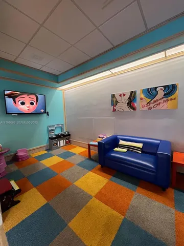 a lobby with furniture and floor to ceiling window