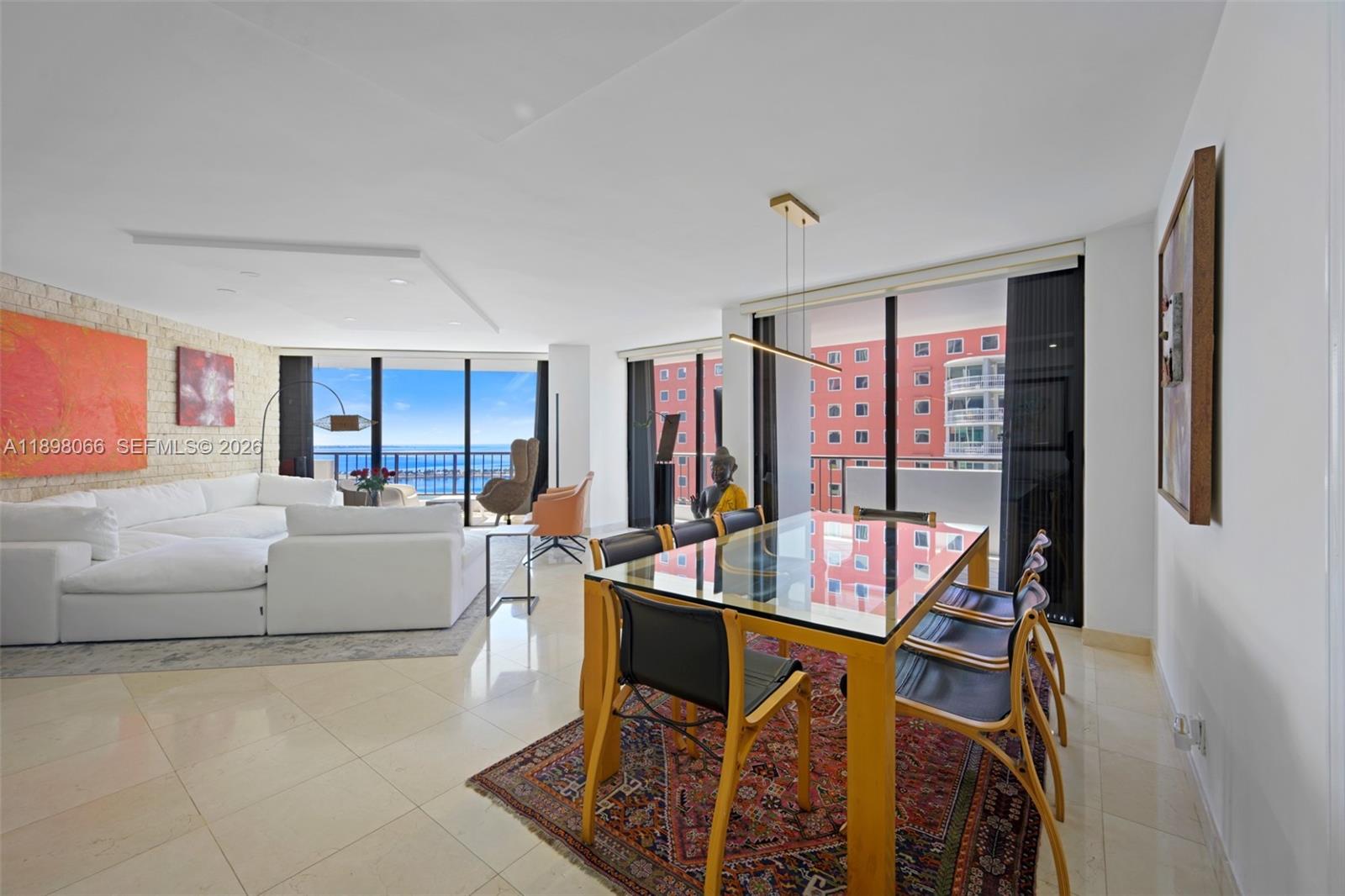 1581 Brickell Avenue, Unit 2005 Miami, FL 33129 - Photo 5 of 38 a living room with furniture a table and a flat screen tv
