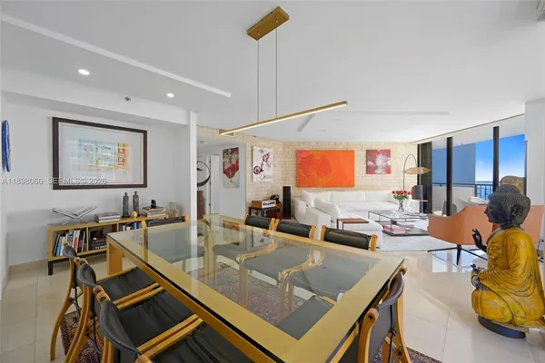 a kitchen with stainless steel appliances granite countertop a refrigerator a stove and a sink