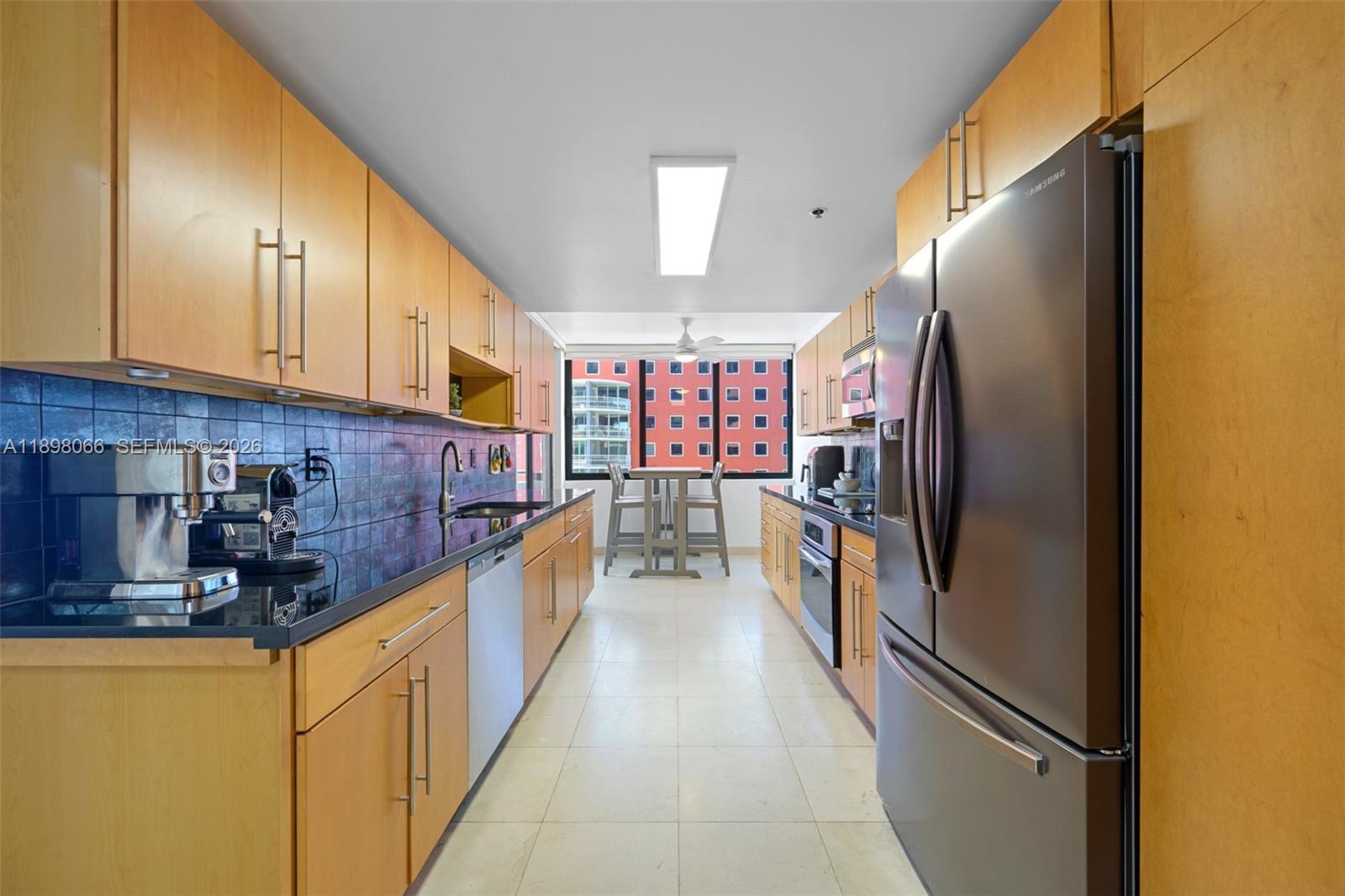 1581 Brickell Avenue, Unit 2005 Miami, FL 33129 - Photo 8 of 38 a kitchen with stainless steel appliances granite countertop a refrigerator a stove and a sink