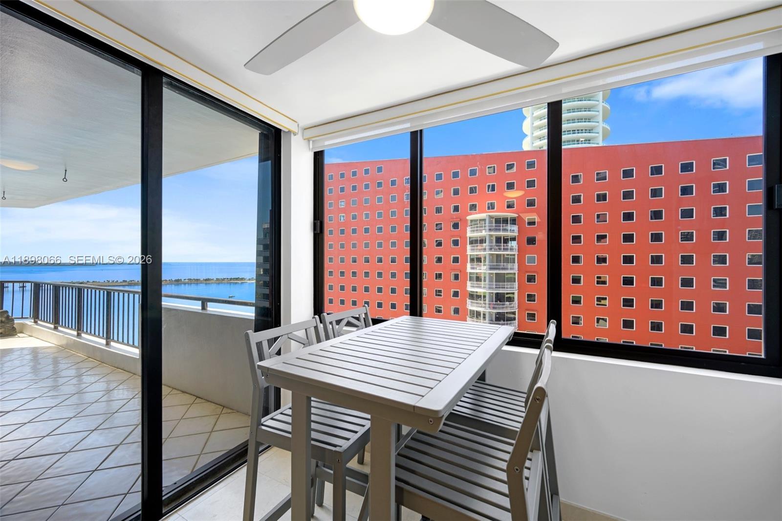 1581 Brickell Avenue, Unit 2005 Miami, FL 33129 - Photo 10 of 38 a view of a large dining room with furniture window and wooden floor