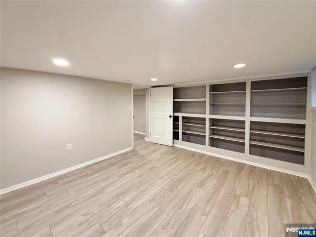 a view of an empty room with a closet and a window