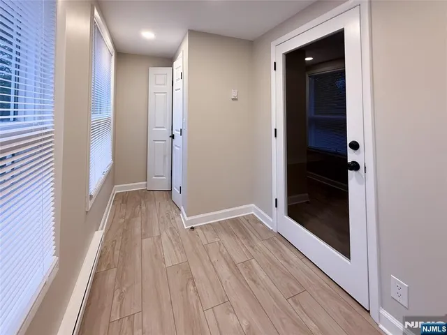 a view of hallway with wooden floor