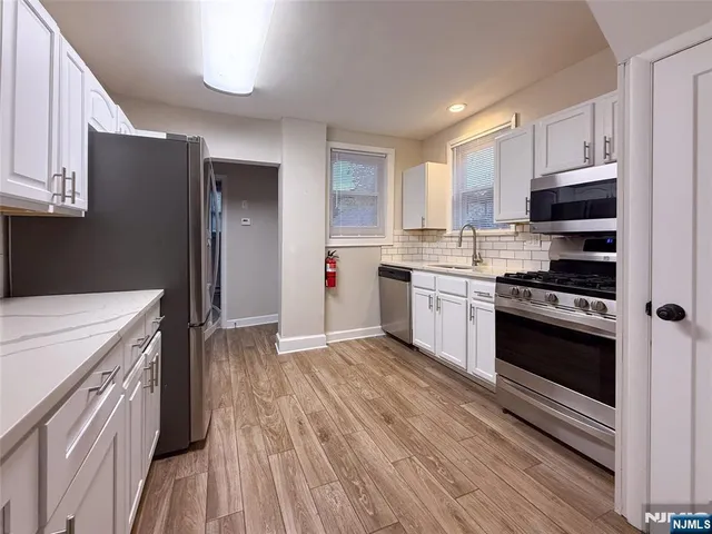a kitchen with a stove a sink and a refrigerator