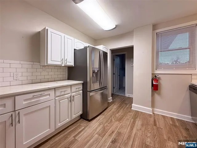 a kitchen with a refrigerator and cabinets