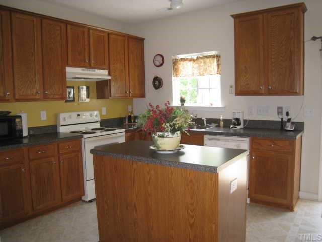 3406 Baton Road Raleigh, NC 27610 - Photo 7 of 12 Another view of the upscale kitchen with tall cabinets and island