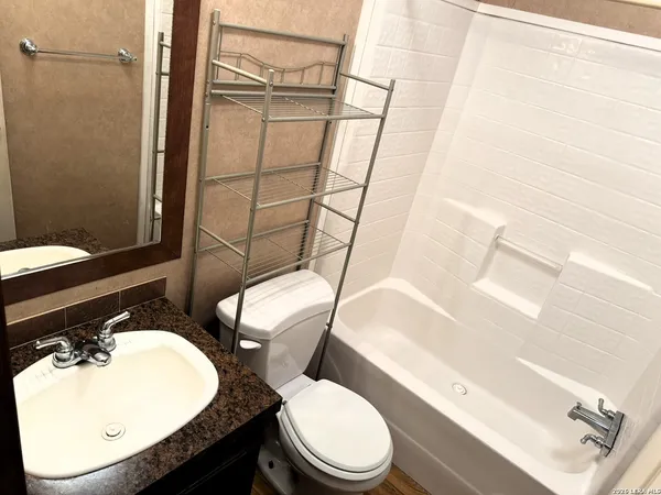 a bathroom with a toilet a sink and bathtub