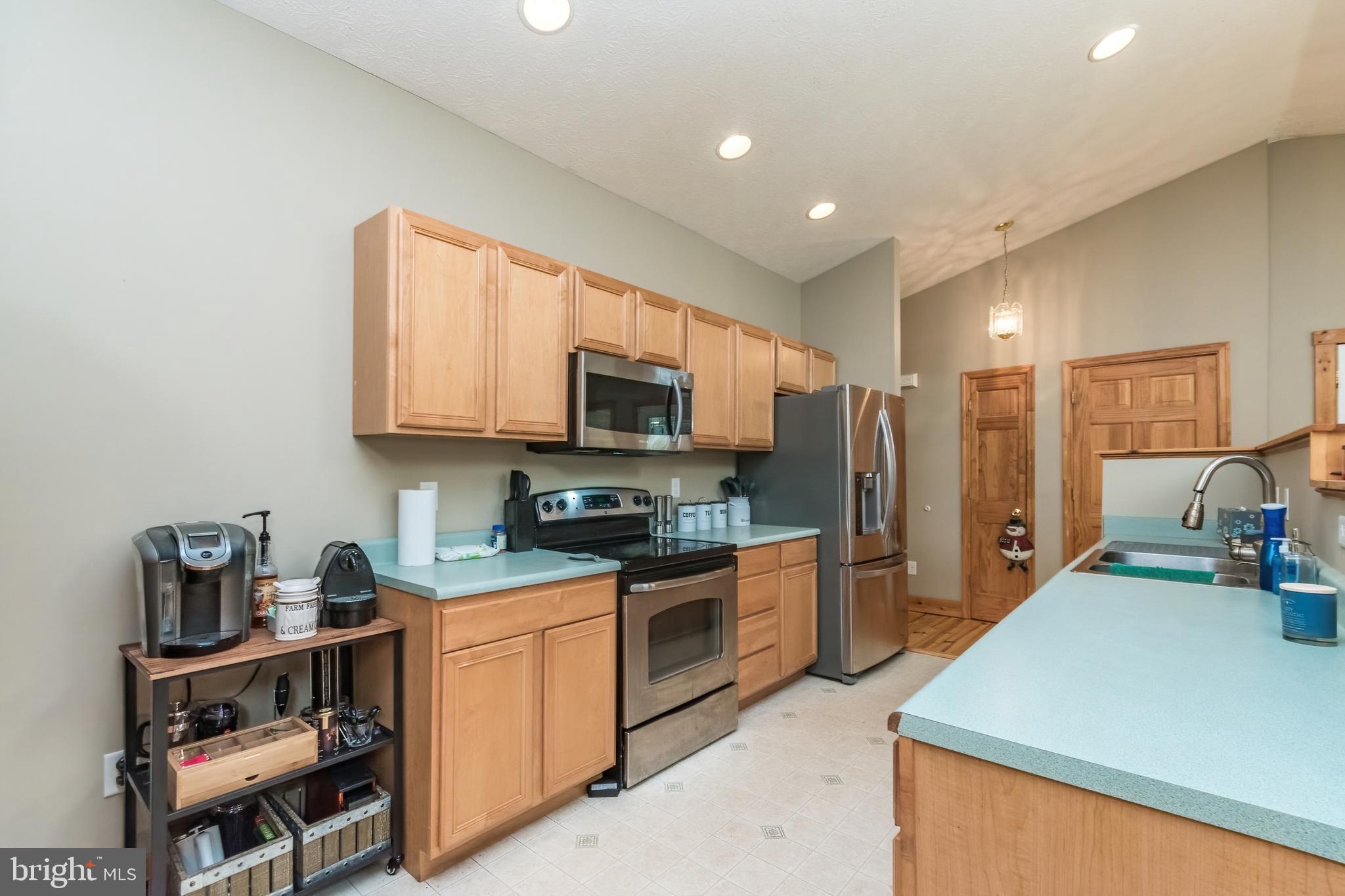 5630 Crooked Run Road Basye, VA 22810 - Photo 24 of 67 a kitchen with stainless steel appliances granite countertop a sink dishwasher stove and refrigerator