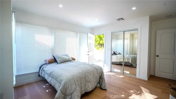 a bedroom with a bed and a walk in closet