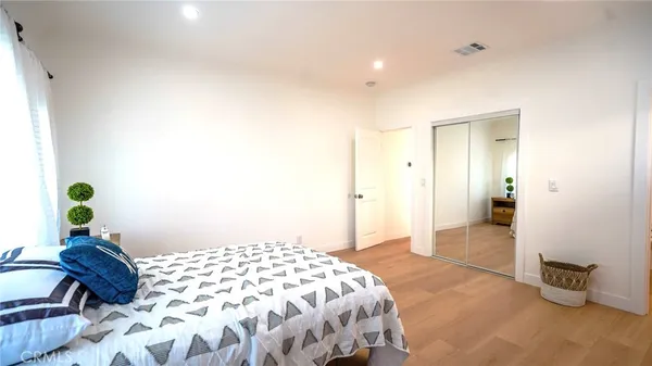 a bedroom with a bed and a dresser
