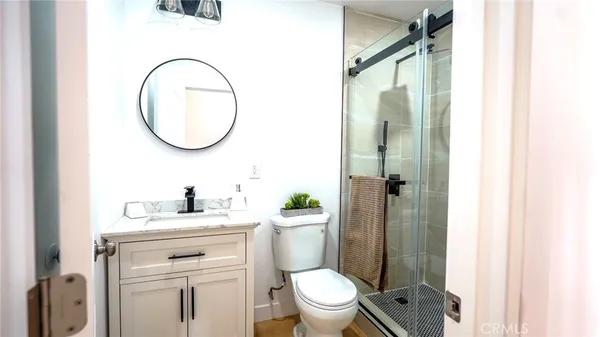a bathroom with a sink a toilet and a mirror