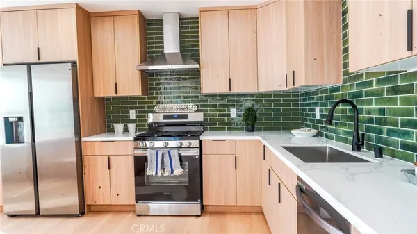 a kitchen with a sink and a refrigerator