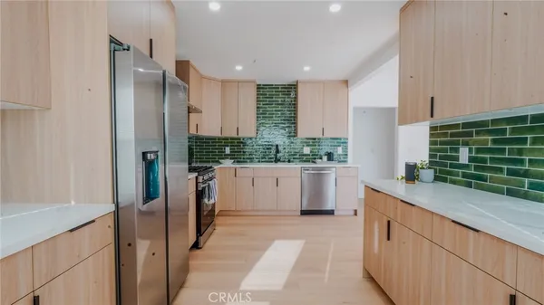 a kitchen with counter top space and stainless steel appliances