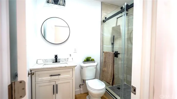 a bathroom with a sink a toilet and a mirror