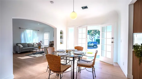 a dining room with furniture and wooden floor
