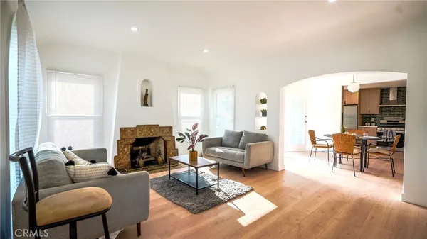 a living room with furniture fireplace and a table