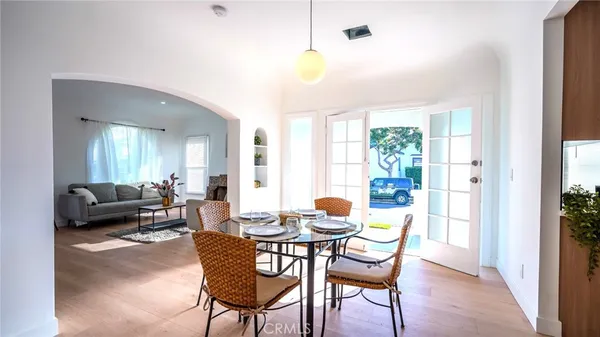 a dining room with furniture and wooden floor