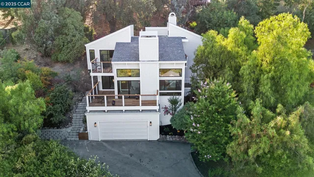 an aerial view of a house with a yard and garden
