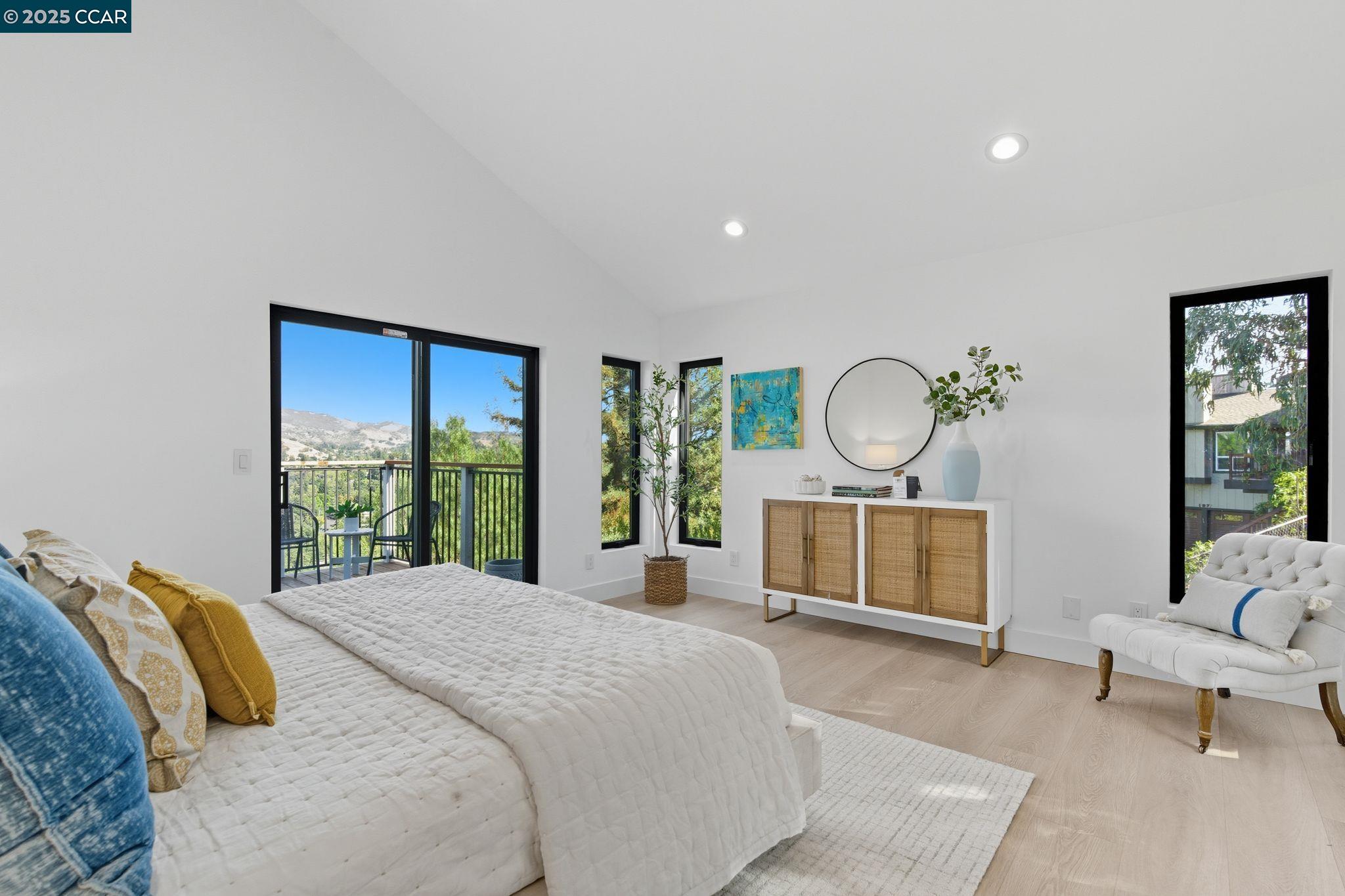 189 Rudgear Drive Walnut Creek, CA 94596 - Photo 31 of 59 a bedroom with a bed a mirror and a large window with balcony view