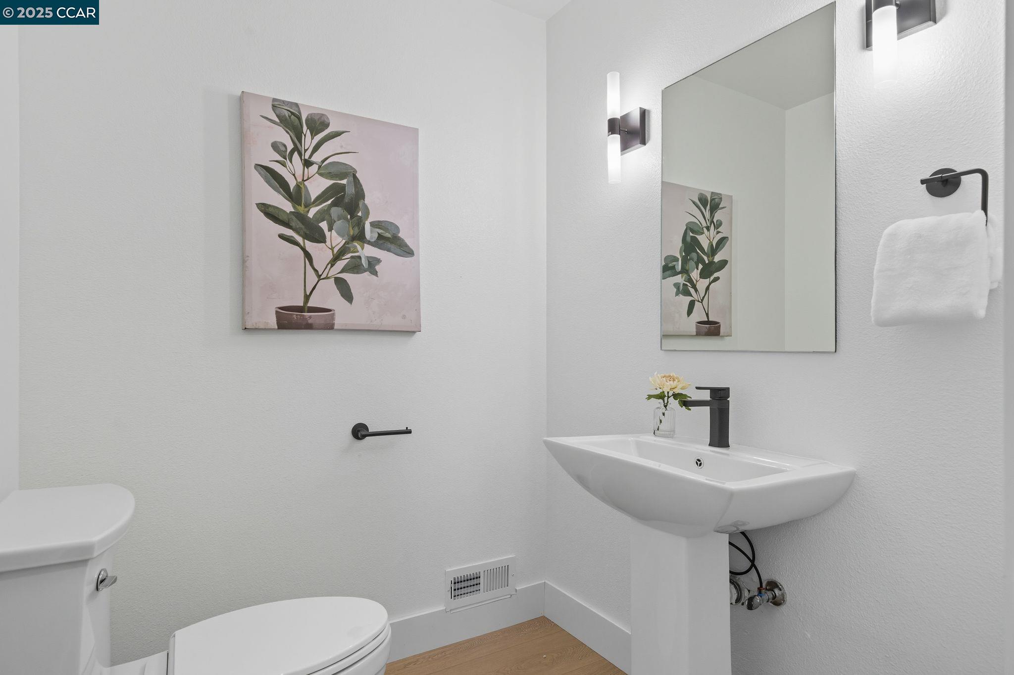 189 Rudgear Drive Walnut Creek, CA 94596 - Photo 52 of 59 a bathroom with a toilet sink and mirror