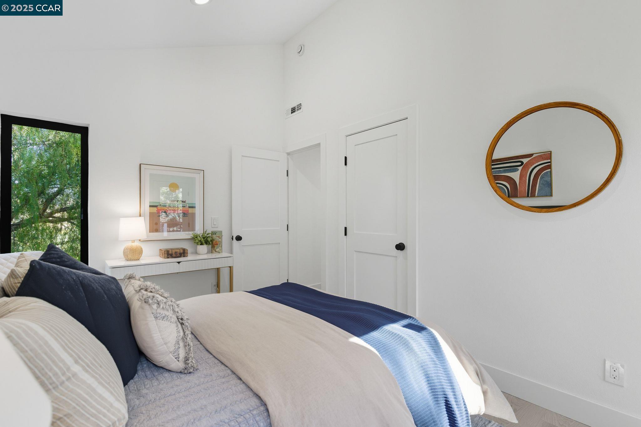 189 Rudgear Drive Walnut Creek, CA 94596 - Photo 54 of 59 a bedroom with a bed and a chandelier