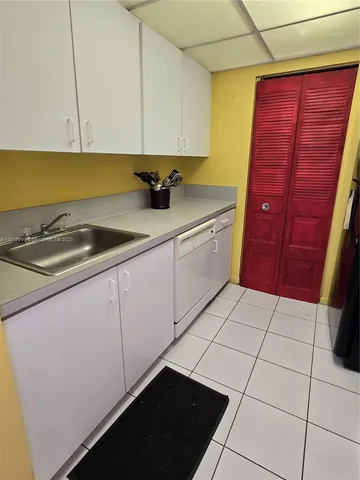 a kitchen with a sink and cabinets